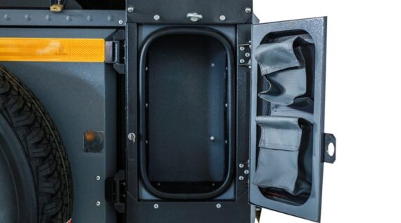 Open left shelf in the Conqueror Compact Platinum Edition for personal belongings storage.