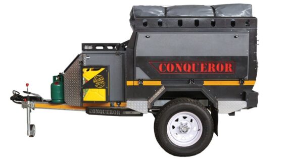 Right side view of the Conqueror Compact Platinum Edition trailer with gas bottles, fuel canister, and rooftop tent.