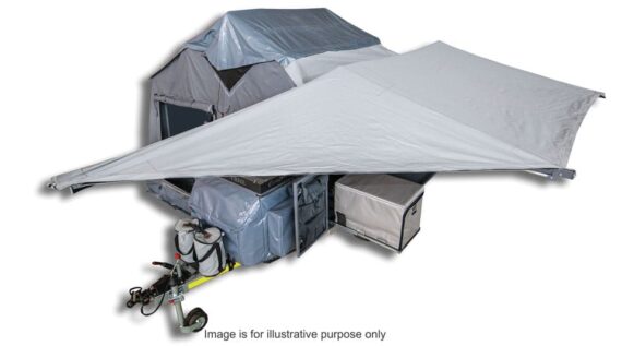 ird's eye view of the fully set up Conqueror Compact Platinum Edition trailer with awning providing shade.